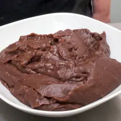Una ciotola bianca piena di deliziosa crema al cioccolato, pronta per essere gustata.