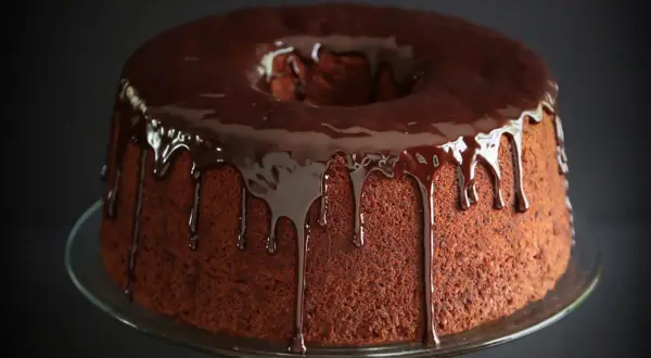 Delizioso chiffon cake al cioccolato con glassa lucida che cola.