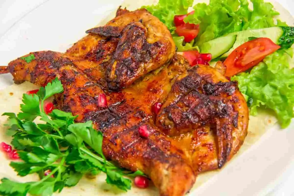 Petto di pollo alla griglia succulento, servito con insalata fresca, pomodoro, cetriolo e chicchi di melograno.