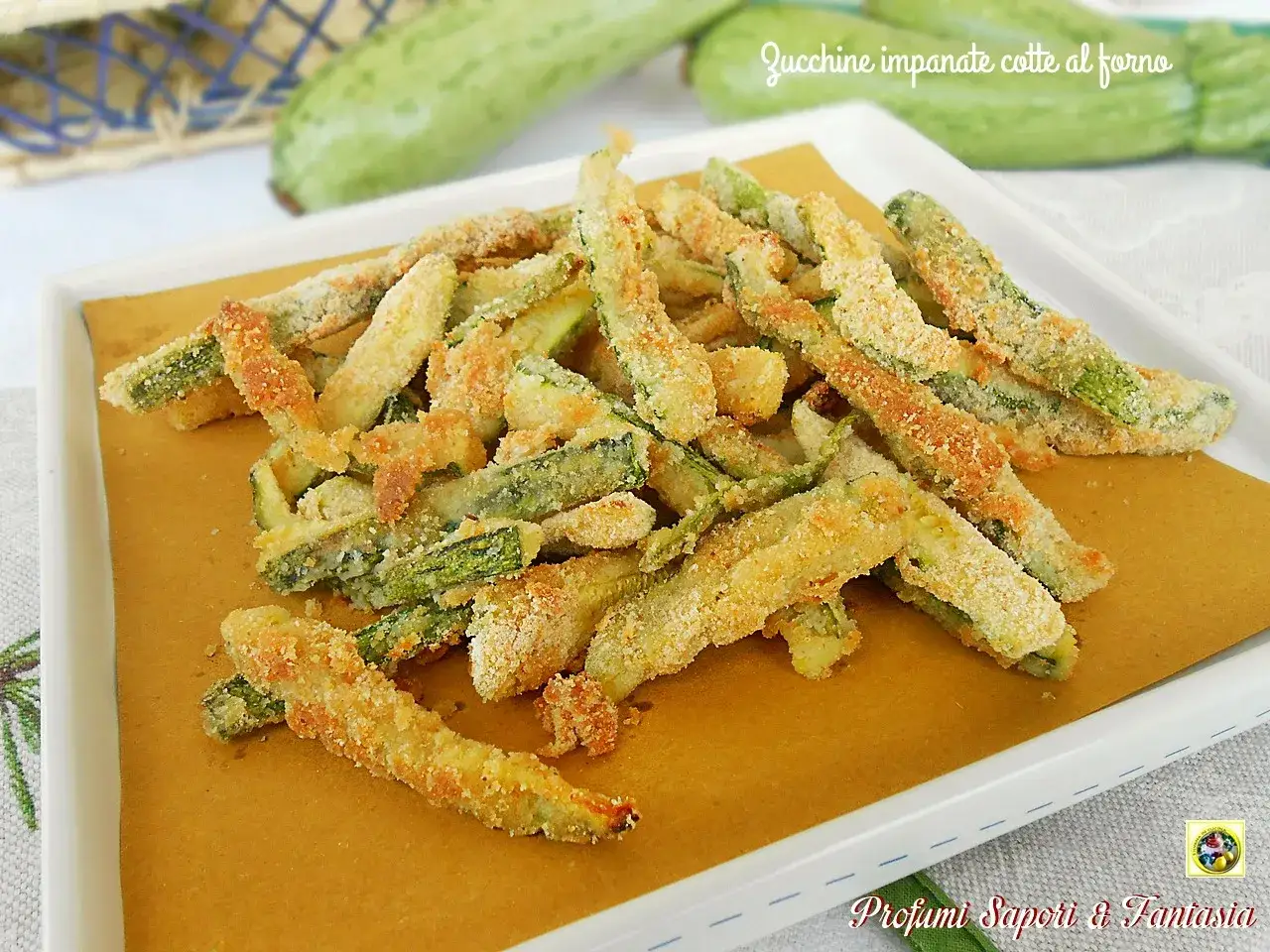 Zucchine al forno dorate e croccanti, tagliate a bastoncino e impanate. Un contorno sfizioso e leggero.