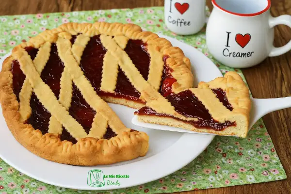 Deliziosa crostata senza uova con marmellata di fragole, perfetta per la colazione o la merenda.